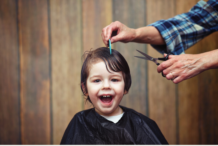 A young boy gets a haircut before the new semester starts
