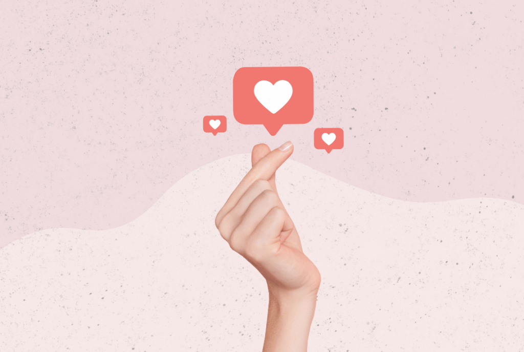Pink background with a hand making a heart shape between the index finger and thumb, and 3 social media hearts above, suggesting the power of Instagram marketing to grow your salon