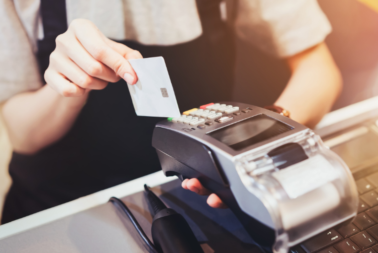 A stylist takes a payment using a card machine