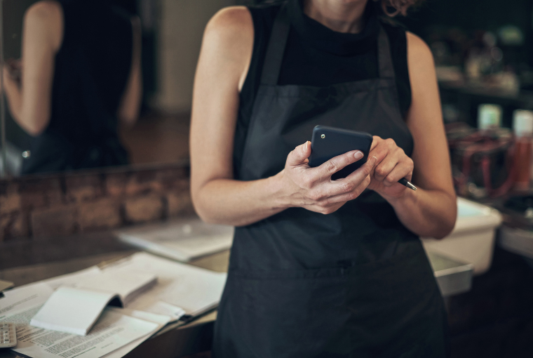 A stylist uses a salon mobile app to check her business performance for the month