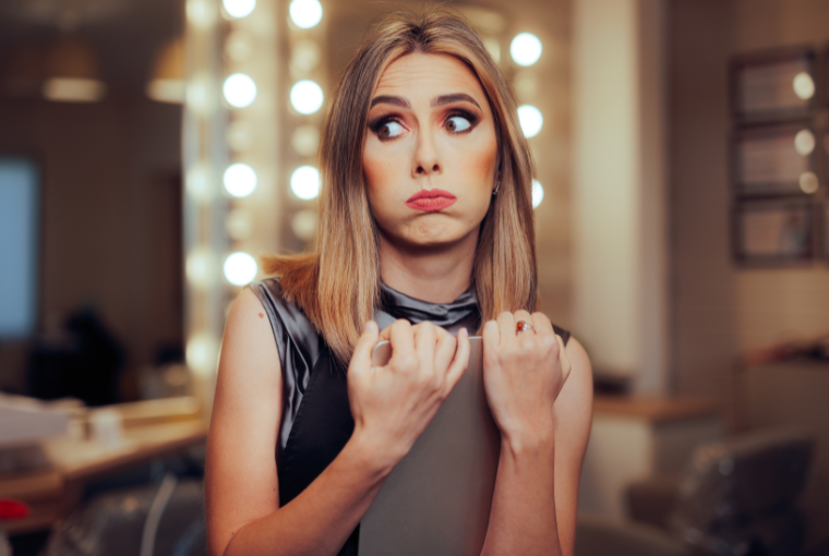 A hairstylist clutches a tablet and looks stressed as she wonders if she needs a 1099