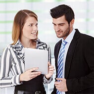 People in an office looking over a tablet